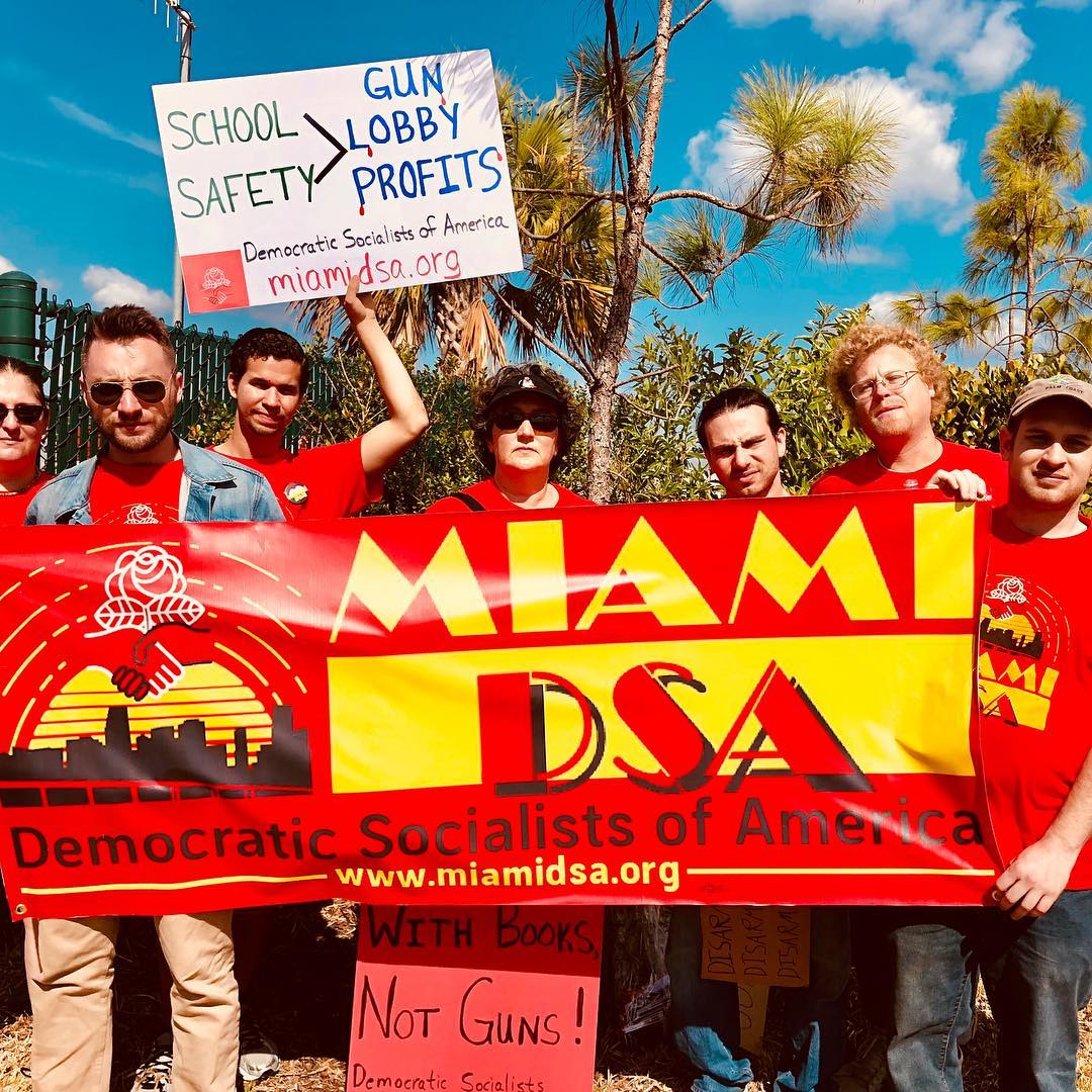 Miami DSA holding banner at March For Our Lives